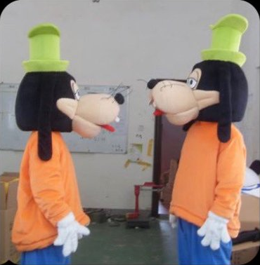 Two people in Goofy costumes standing in a messy storage room