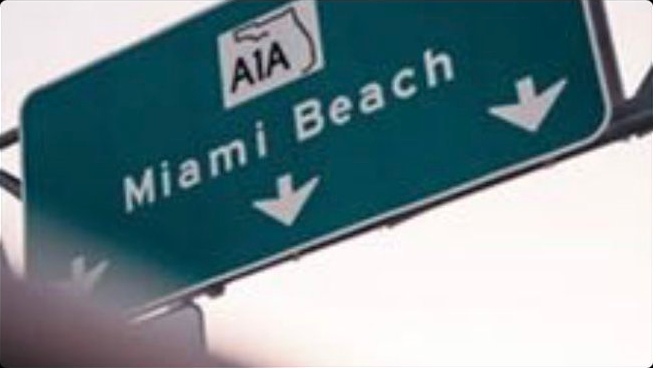 A road sign showing the way to Miami Beach