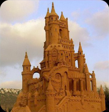 A ridiculously large and elaborate sand castle, like it was clearly made by a sand artist not a normal person