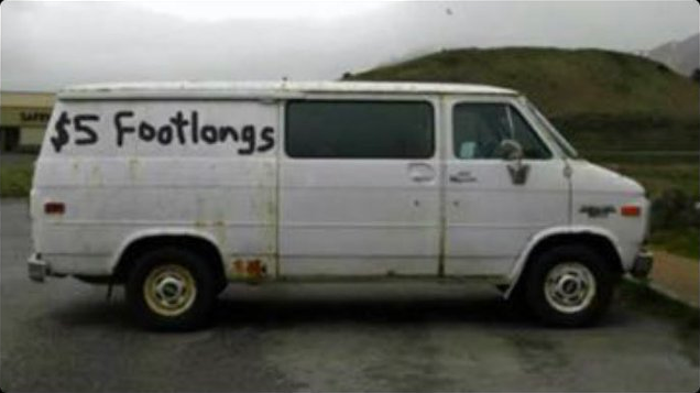 A rusty old van with ‘$5 Footlongs’ badly spraypainted onto the side.