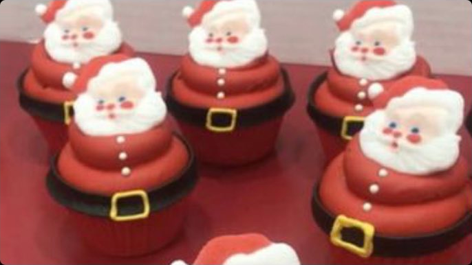 Several cupcakes all nicely decorated to look like Santa Claus